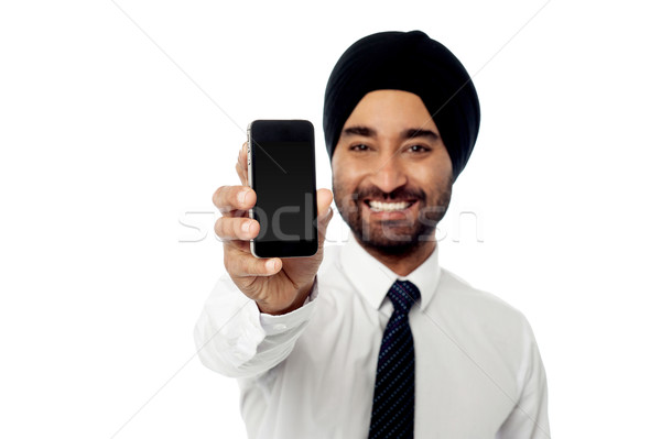 Smiling man showing his new mobile phone Stock photo © stockyimages