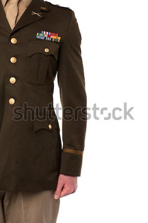 Young man in military uniform, cropped image Stock photo © stockyimages