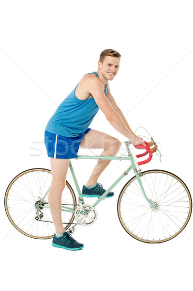 A young male bicyclist riding a bicycle Stock photo © stockyimages