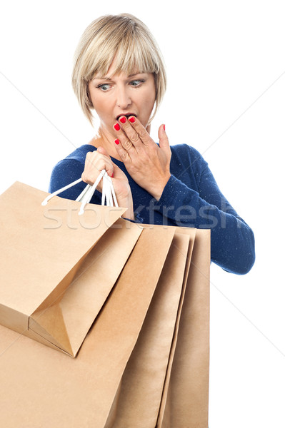 Amazed shopping woman isolated on white Stock photo © stockyimages
