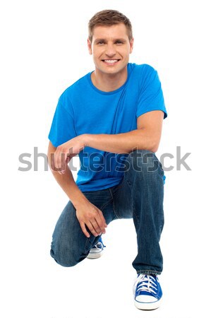 Casual cool young guy semi seated on floor Stock photo © stockyimages