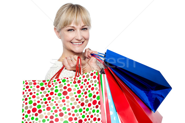 Pretty female carrying shopping bags over shoulders Stock photo © stockyimages