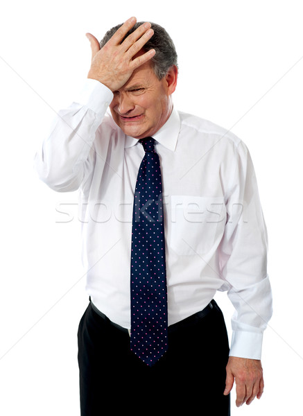 Sad old corporate man with hand on head Stock photo © stockyimages
