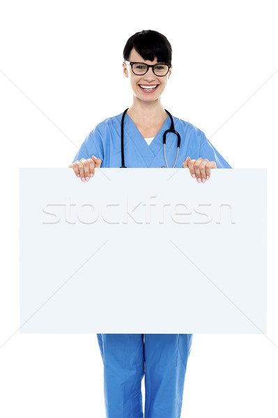 Medical practitioner holding blank ad board Stock photo © stockyimages