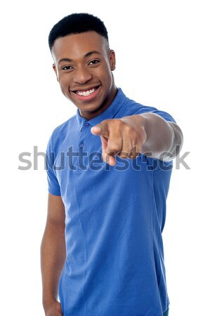 Cheerful guy pointing towards camera Stock photo © stockyimages