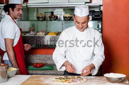 Chef preparing pizza base Stock photo © stockyimages