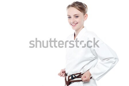 Smiling karate girl isolated over white Stock photo © stockyimages