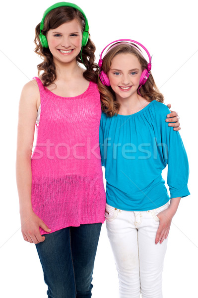 Girls standing together and enjoying music Stock photo © stockyimages