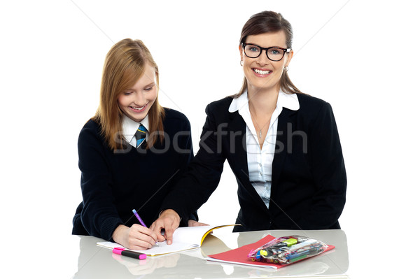 Bespectacled teacher pointing out the mistakes Stock photo © stockyimages