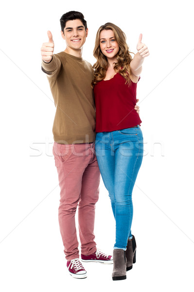 Friends gesturing thumbs up sign Stock photo © stockyimages