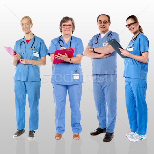 Stock photo: Senior team of doctors posing with a smile