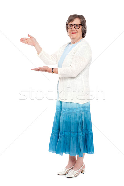 Stock photo: Beautiful aged female showing copy space