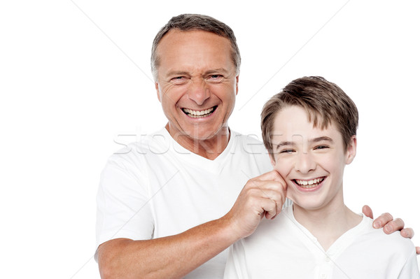 Father and son playing, pinching cheeks Stock photo © stockyimages