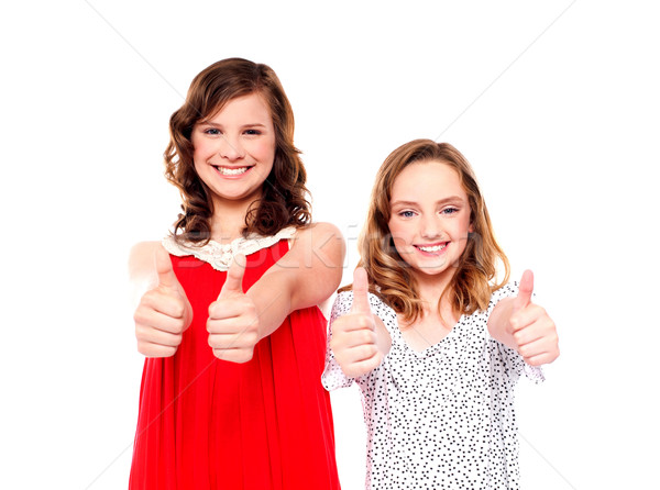 Two friends gesturing thumbs up Stock photo © stockyimages