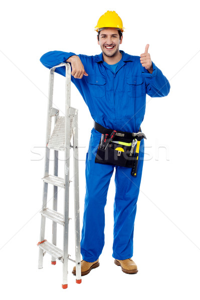 Plumber posing confidently with thumbs up Stock photo © stockyimages