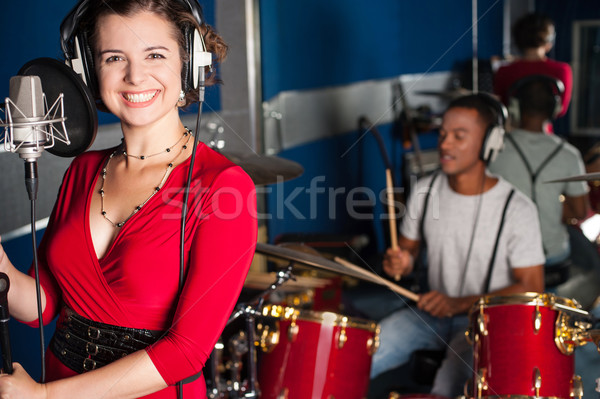 Female singer recording a track in studio Stock photo © stockyimages