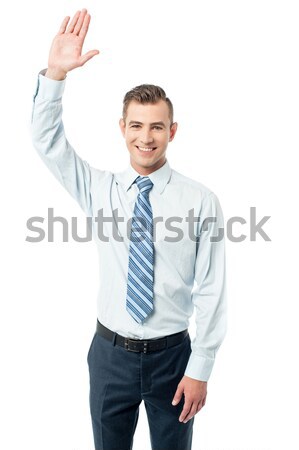Business execuitve raising his hand Stock photo © stockyimages
