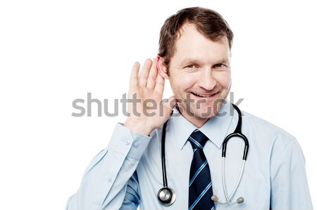 Physician listening with his hand on an ear Stock photo © stockyimages