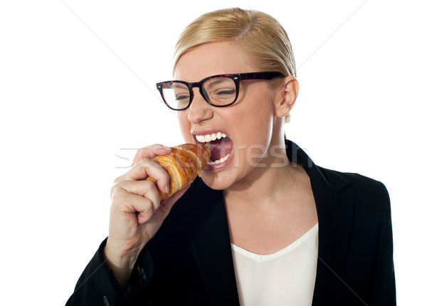 Beautiful businesswoman eating Stock photo © stockyimages