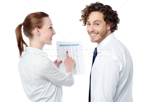 Lady pointing at statistics given on report Stock photo © stockyimages