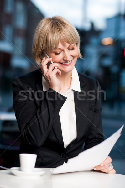 Manager communicating via cell phone in cafe Stock photo © stockyimages