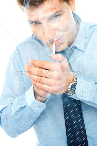 Joven iluminación cigarrillo blanco negocios mano Foto stock © stockyimages