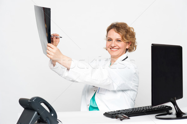 Surgeon pointing at diseased area with pen Stock photo © stockyimages