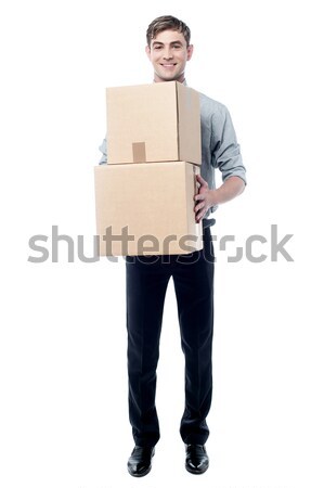 Young man holding cardboard boxes Stock photo © stockyimages