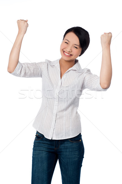Excited charming girl with clenched fists Stock photo © stockyimages