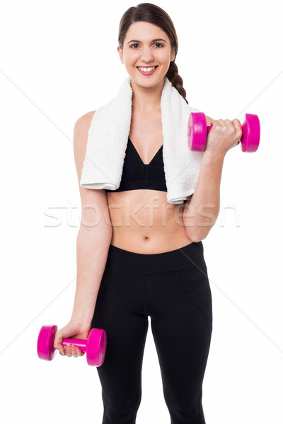 Stock photo: Fitness female instructor lifting dumbbells