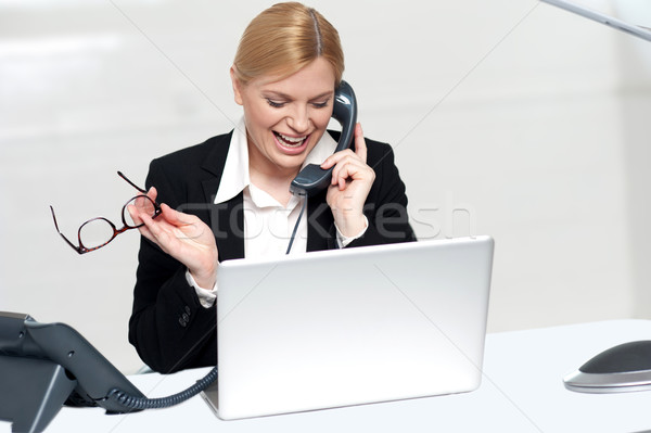 Woman talking on phone holding eye glasses Stock photo © stockyimages