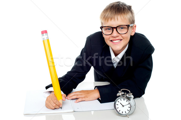 Casual shot of a school kid finishing his assignment in time Stock photo © stockyimages