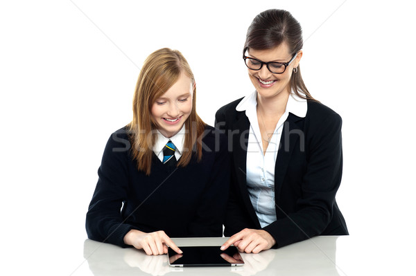Educator and student exploring a tablet device Stock photo © stockyimages