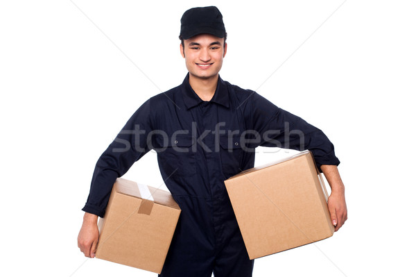 Young courier guy holding boxes Stock photo © stockyimages