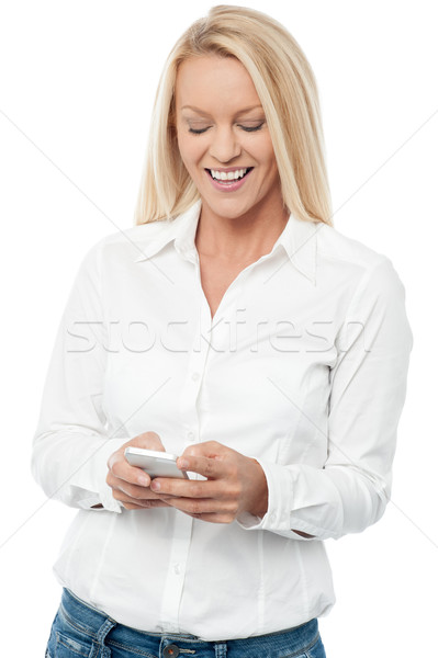 Happy woman with mobile phone Stock photo © stockyimages