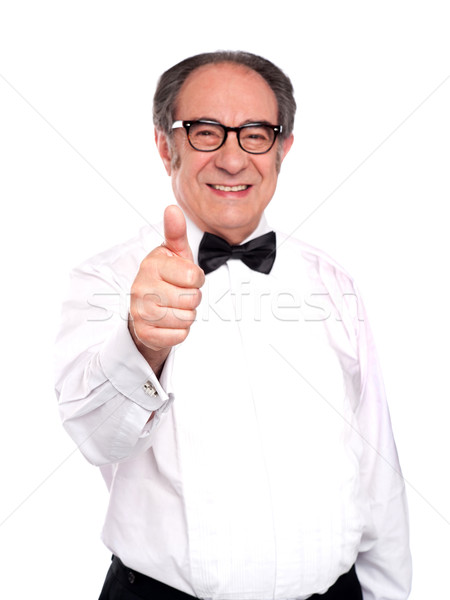 Smiling old man gesturing thumbs up Stock photo © stockyimages