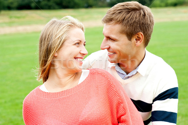 Couple admiring each other and smiling heartily Stock photo © stockyimages