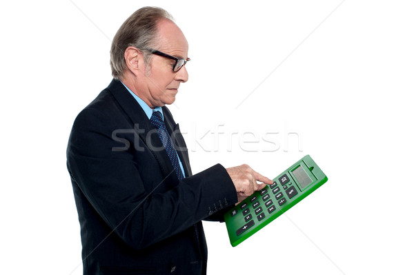 Intent looking executive working on a calculator Stock photo © stockyimages