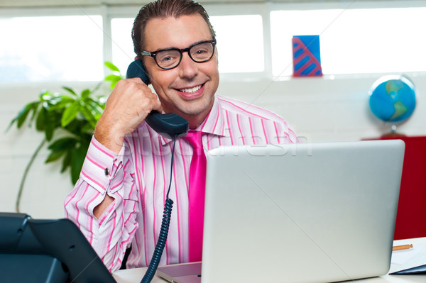 Happy executive engaged on a business call Stock photo © stockyimages