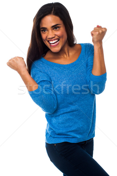 Excited pretty girl with clenched fists Stock photo © stockyimages