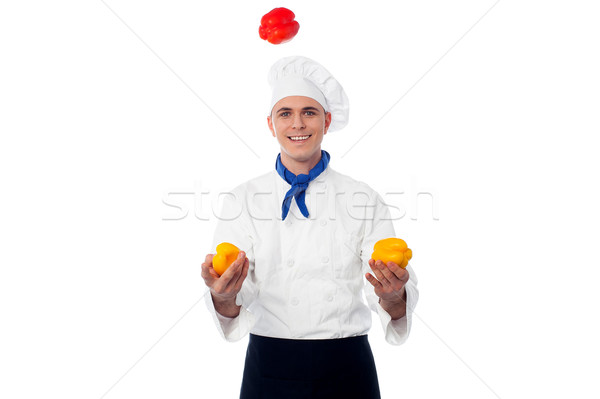 Skilled chef juggling with capsicums Stock photo © stockyimages