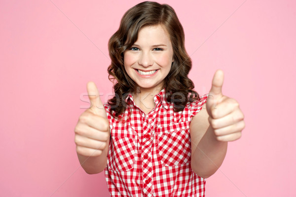Gorgeous girl showing double thumbs up Stock photo © stockyimages