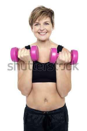 Cheerful middle-aged woman woman working out Stock photo © stockyimages