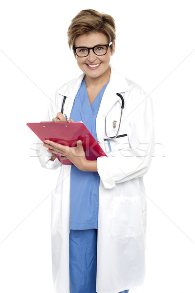 Stock photo: Female doctor with a case file in her hand