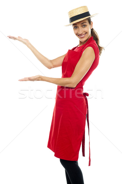 Smiling cook presenting copy space, open palms Stock photo © stockyimages
