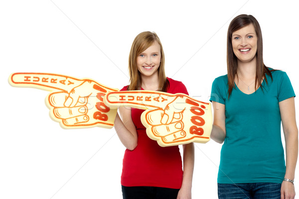 Cheerful fans pointing the big foam hand sideways Stock photo © stockyimages
