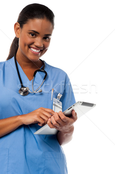 Stock photo: Female physician browsing on tablet pc