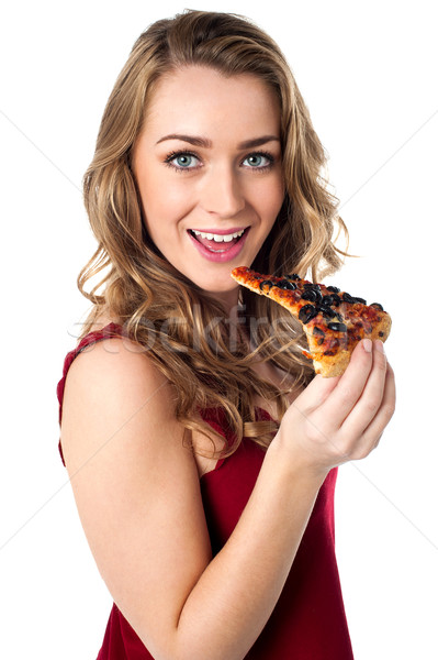 Stock photo: Attractive young female posing with a slice of pizza in hand