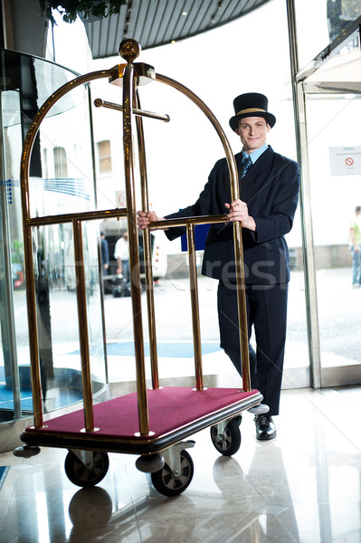 Profile shot of a doorman holding a cart Stock photo © stockyimages