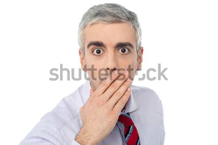 Senior mature man closing mouth with hand Stock photo © stockyimages